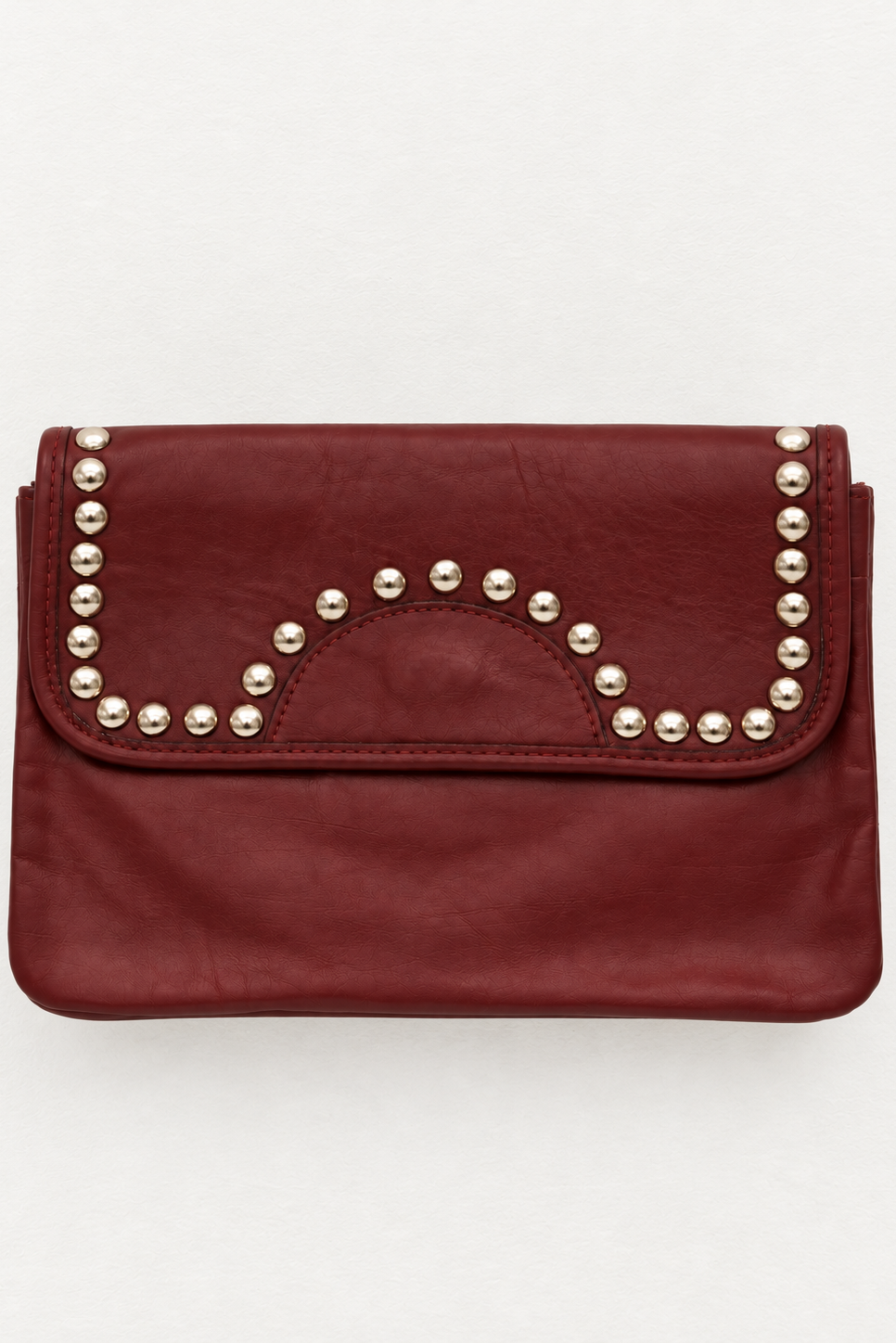 A burgundy leather clutch bag with silver-tone metal studs arranged in a semicircle on the front flap, set against a plain light gray background.